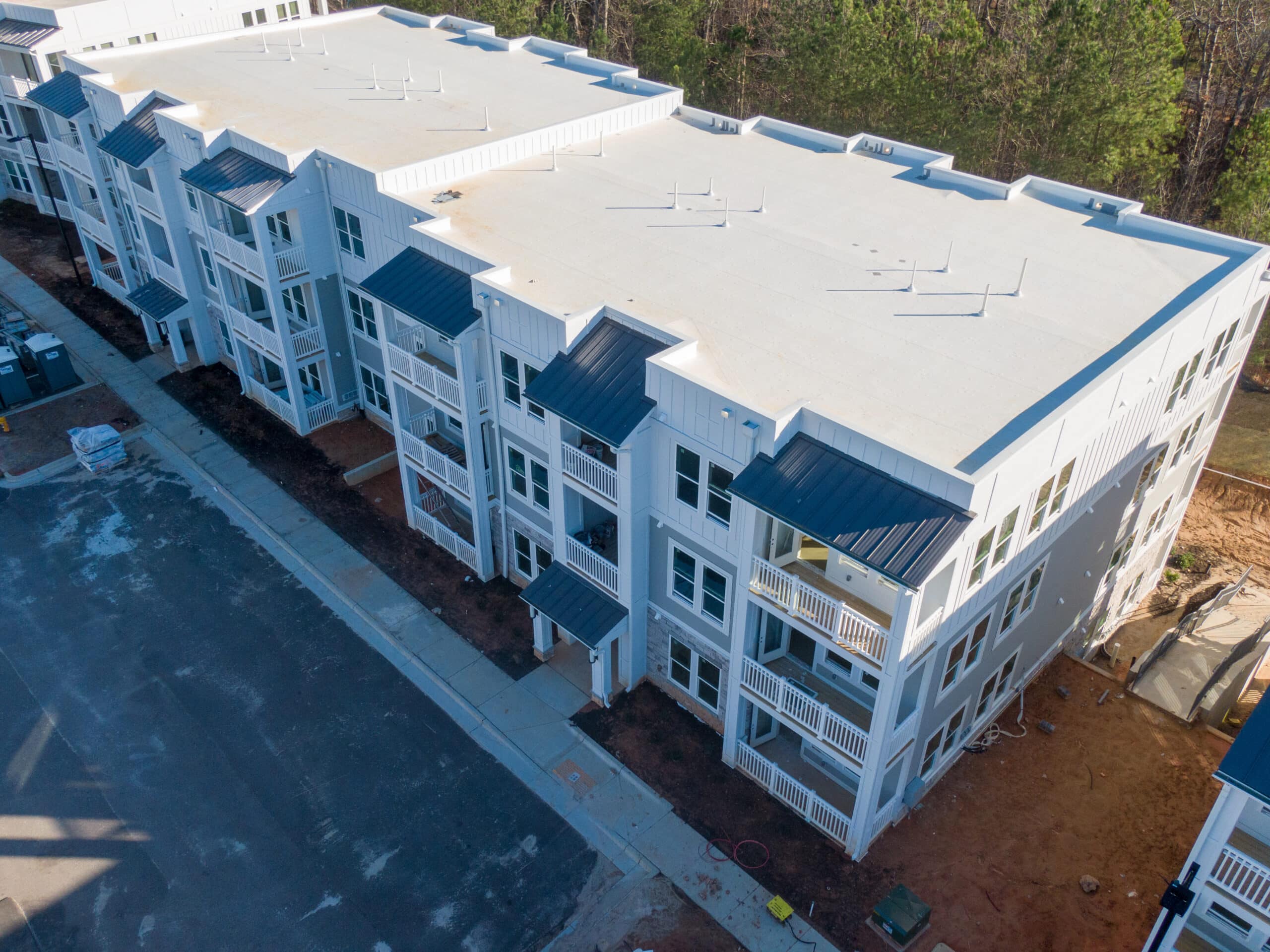 Professional Aerial Drone Photo of An Apartment Building Under Construction With A TPO Roof: Architecture, Construction, Industry, Real Estate Comprehensive Commercial Roofing Services