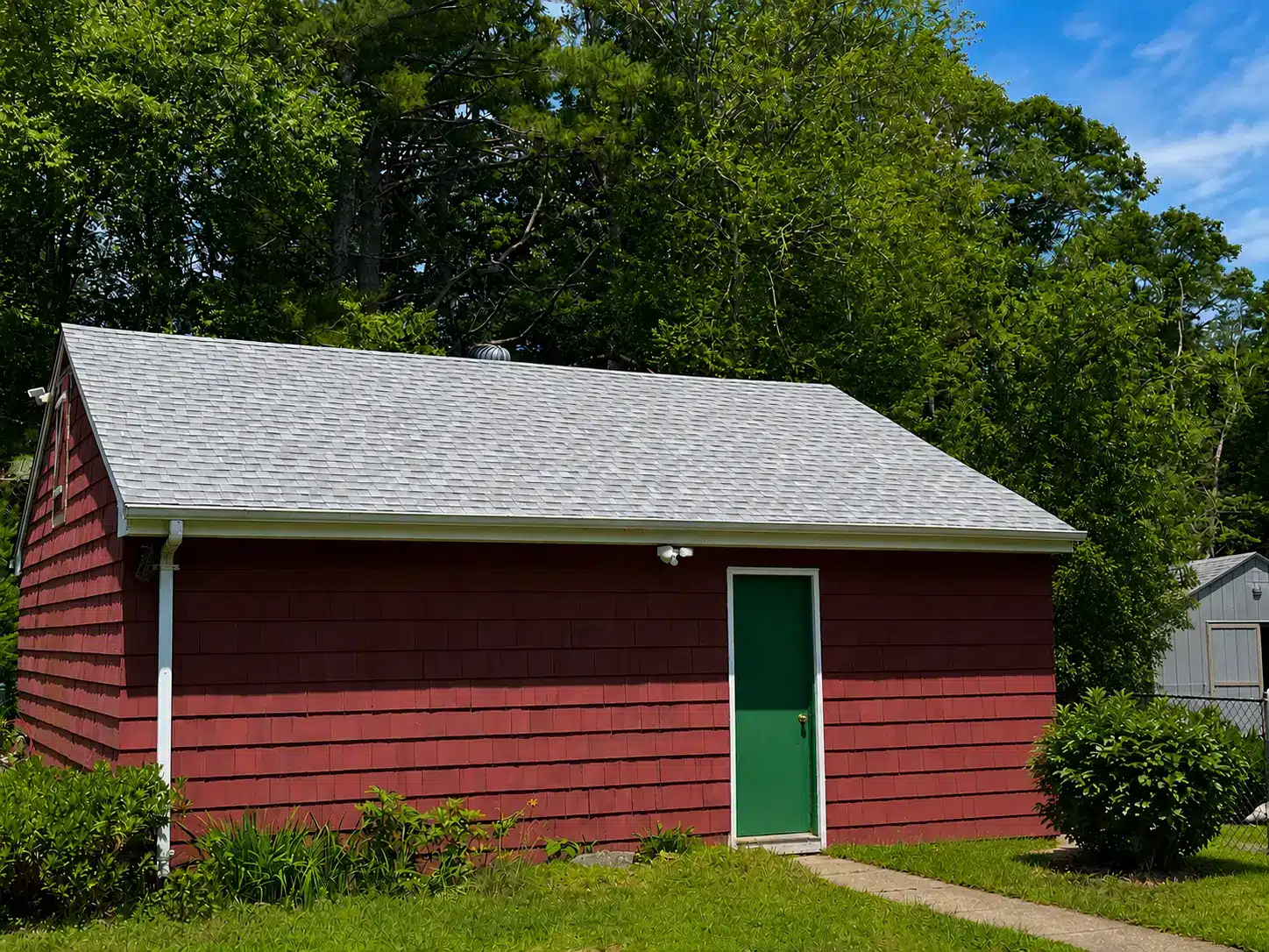 Professional residential and garage roof replacement project completed in Charlestown RI by Pawcatuck Roofing Company.