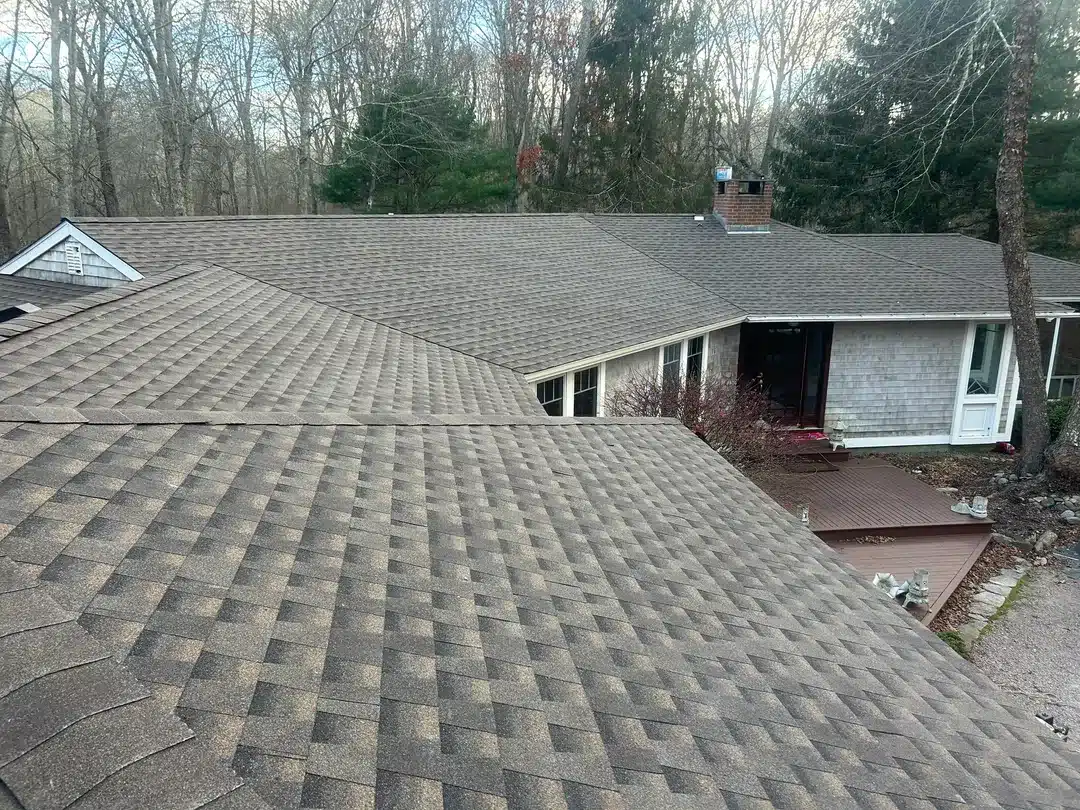 Custom roof replacement and Broan vent installation project in Stonington CT by Pawcatuck Roofing Company.