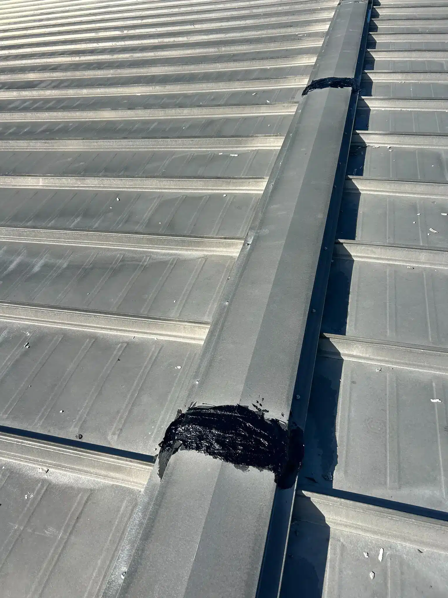 Commercial metal roof repair and sealing project completed in Bozrah, CT by Pawcatuck Commercial Roofing.